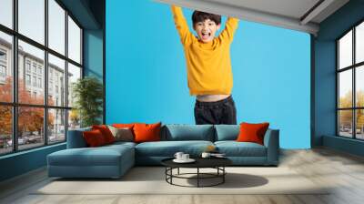 full body image of asian boy posing on blue background Wall mural