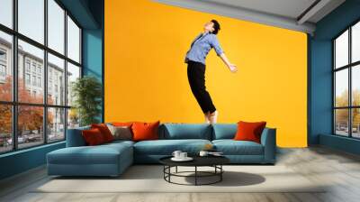 full body image of asian man posing on yellow background Wall mural