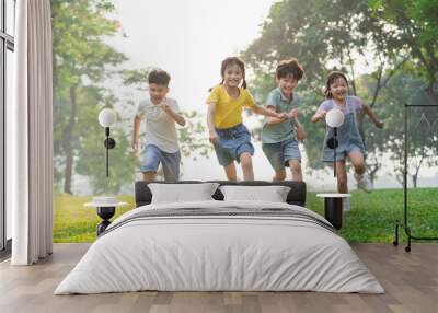 group image of asian children having fun in the park Wall mural