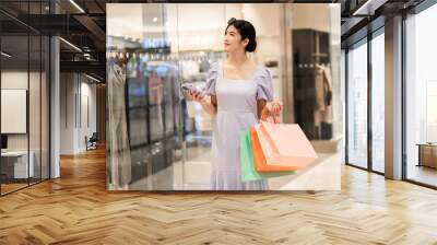 happy Asian woman shopping at mall Wall mural