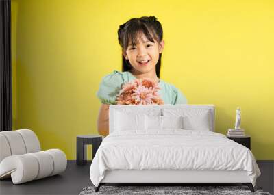 happy smiling asian girl on yellow background Wall mural