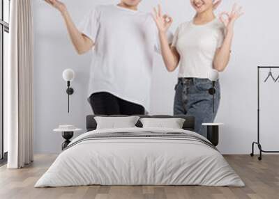 Image of Asian couple posing on white background. Wall mural