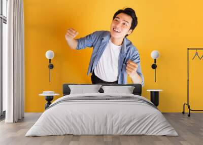 image of asian man posing on a yellow background Wall mural