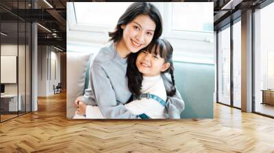 image of mother and daughter cuddling on the sofa Wall mural