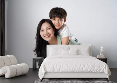 mother and son posing on a white background Wall mural