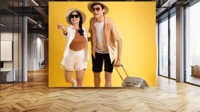 Portrait image of couple posing on yellow background, summer, travel Wall mural