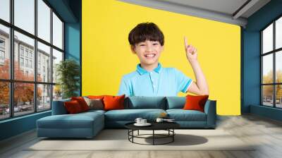 portrait of an asian boy posing on a yellow background Wall mural