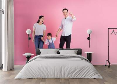 young asian family image isolated on pink background Wall mural