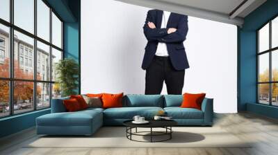 Young business man wearing a suit posing on a white background Wall mural