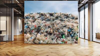 A mountain of plastic waste against the sky Conceptualise the critical need for recycling and waste management initiatives. Wall mural