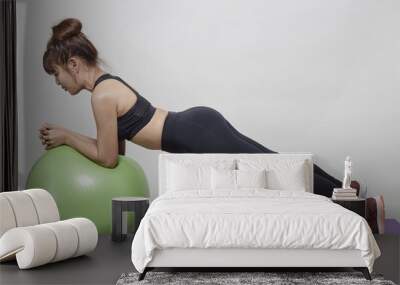 Sporty young woman training in gym Wall mural