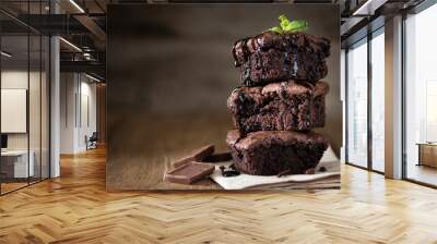 A stack of chocolate brownies on wooden background with mint leaf on top, homemade bakery and dessert Wall mural