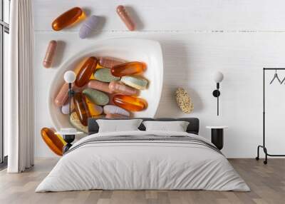 Variety of vitamin pills on white wooden background, supplemental and healthcare product, flat lay surface Wall mural