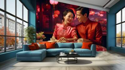 A Chinese couple in Chinese traditional wedding dress sitting and smiling to each other in restaurant full of red traditional hanging lanterns  Wall mural