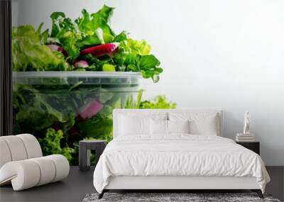 Fresh salad in a container with greens on a white background Wall mural