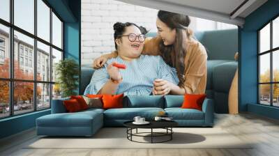 happy family father and mother take care adopted daughter down syndrome girl spend time together family doing activity together with smile. Wall mural