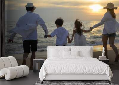 happy family playing water on beach at sunset, Family playing together on beach holiday vacation, Freedom lifestyle and beach travel concept Wall mural