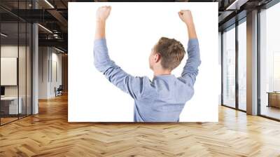 Rear view of successful student boy teenager raising hands up isolated over white background. Adolescent guy celebrate victory as a winner. Wall mural