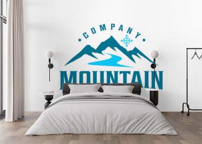 Outdoor design logo rocky snowy mountain peak with flowing river. Wall mural