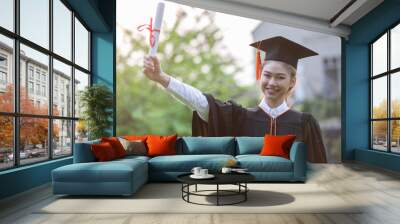 Attractive Asian Women Student Graduate in cap and gown celebrating with certificate in hand and so proud happiness in Commencement day,Congratulation of student in graduation day,Education Success Wall mural