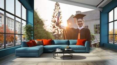 Attractive Asian Women Student Graduate in cap and gown celebrating with certificate in hand and so proud happiness in Commencement day,Congratulation of student in graduation day,Education Success Wall mural