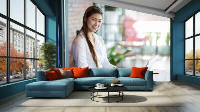 Beautiful Attractive Asian woman working with computer laptop and thinking to get ideas and requirement in Business startup feeling so happiness,Business Startup Concept Wall mural