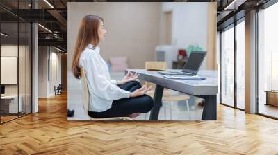 Woman doing yoga in office relax after working hard feeling so happiness and comfortable,Business and Healthy Concept Wall mural