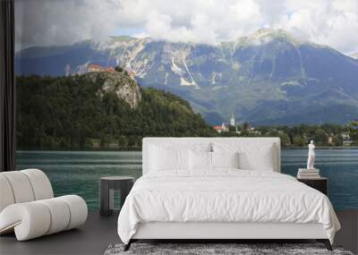 Lake Bled Slovenia. Beautiful mountain lake in summer with small Church on an island with castle on cliff and european alps in the background. Wall mural