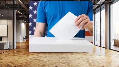 Persons Hand with ballot and voting box on Flag of USA Wall mural