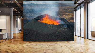 Stunning shot of dramatic moment of a volcano eruption, summit crater with boiling magma, aerial directly above view. Powerful force of nature concept. Wall mural