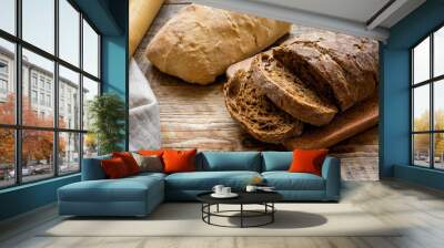 Baking homemade bread on wooden background Wall mural