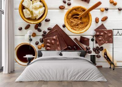 Chocolate bars and nuts on white wooden table background top view Wall mural