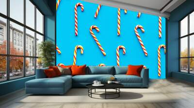 Christmas candy cane pattern on blue background top-down Wall mural