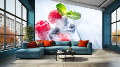 cubes of berry ice and mint leaf on wooden table beckground Wall mural