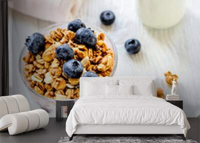 Fitness breakfast with granola, milk and honey on white backgrou Wall mural