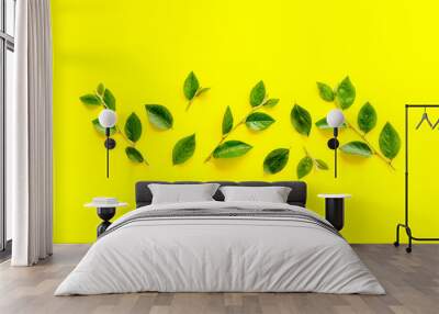 Frame of green leaf branches, top view. Floral pattern background Wall mural