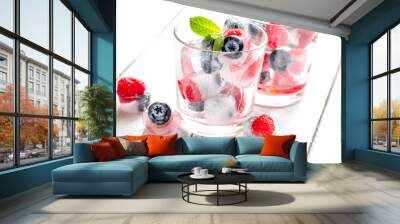 glass with frozen berries in cubes on wooden desk background Wall mural