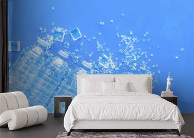 Plastic bottles with pure water and ice on blue background top v Wall mural