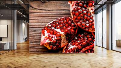 sliced pomegranate on wooden background top view Wall mural