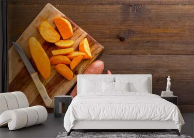 Sliced sweet potato on cutting board, top view Wall mural