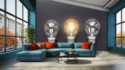 three concept of idea illustration lit lamp on black background Wall mural