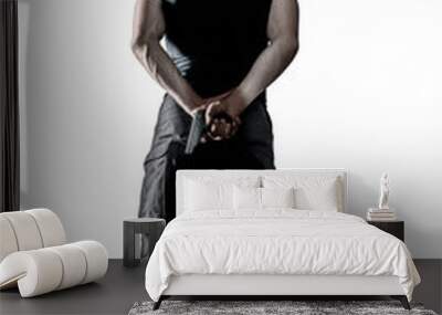 Man in black uniform and mask standing with gun isolated Wall mural