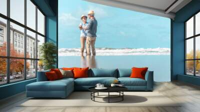 An old Asian couple is dancing by the sea, the atmosphere is good. Wall mural