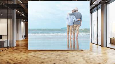 Beautiful happy elderly couple rest at tropical resort,back view Wall mural