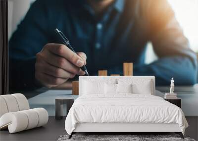 A man is writing on a piece of paper with a pen Wall mural