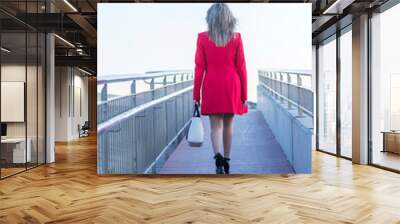 Blonde woman walking away over the runaway Wall mural