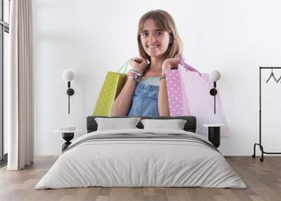 Woman with shopping bags isolated over a white background Wall mural