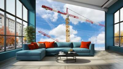 2 tower cranes on cloud and blue sky background Wall mural