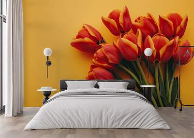 A festive holiday banner featuring a stunning bouquet of red tulips set against a vibrant yellow backdrop creating a beautiful greeting card This flat lay composition embodies the essence o Wall mural