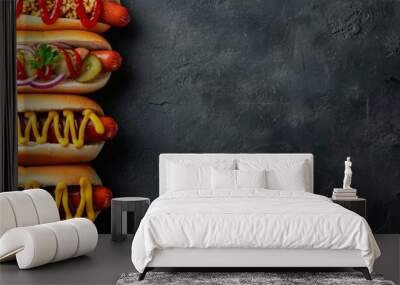 a stack of hot dogs with ketchup and mustard on a black background . High quality Wall mural